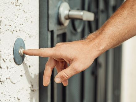 Smart video doorbell mounted next to entry door