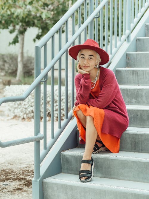 Woman in Red Jacket Wearing Red Fedora Hat 