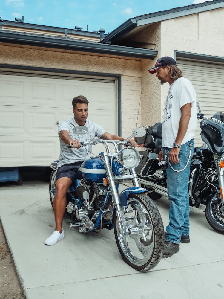 Handsome Man Riding A Blue Motorcycle 