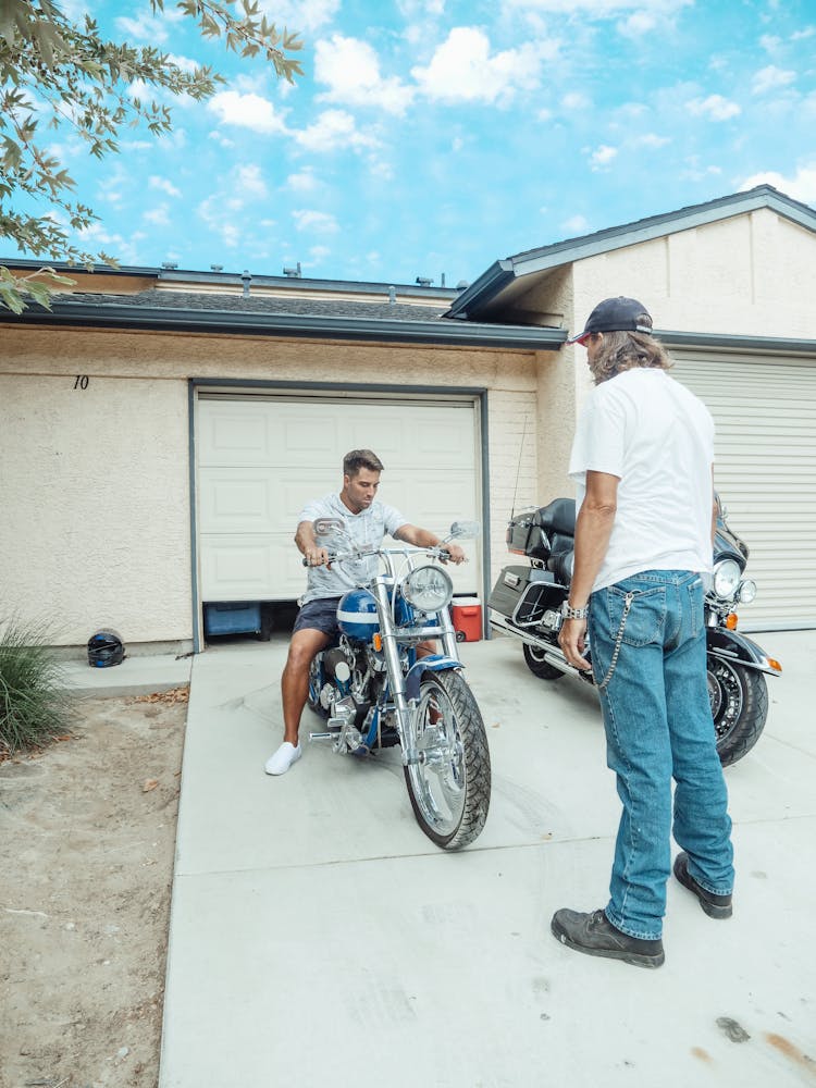 Men Looking At A Motorbike