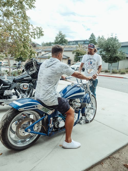 Man in White and Gray Ridding Blue Motorcycle