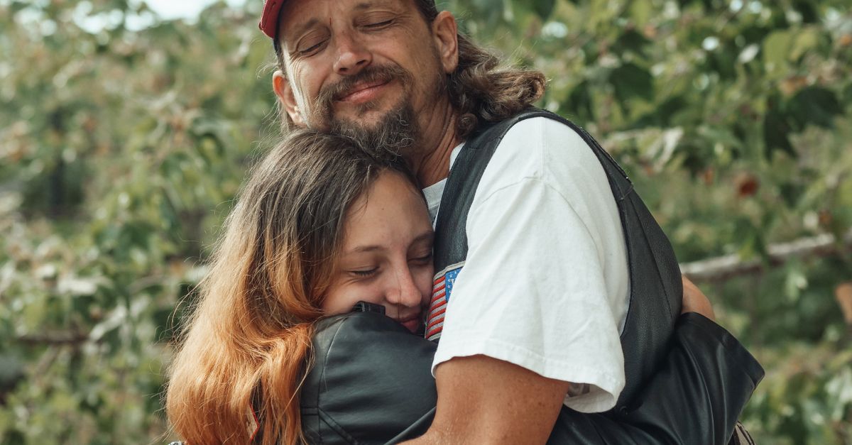 Father Gregory Boyle hugging a former gang member at Homeboy Industries