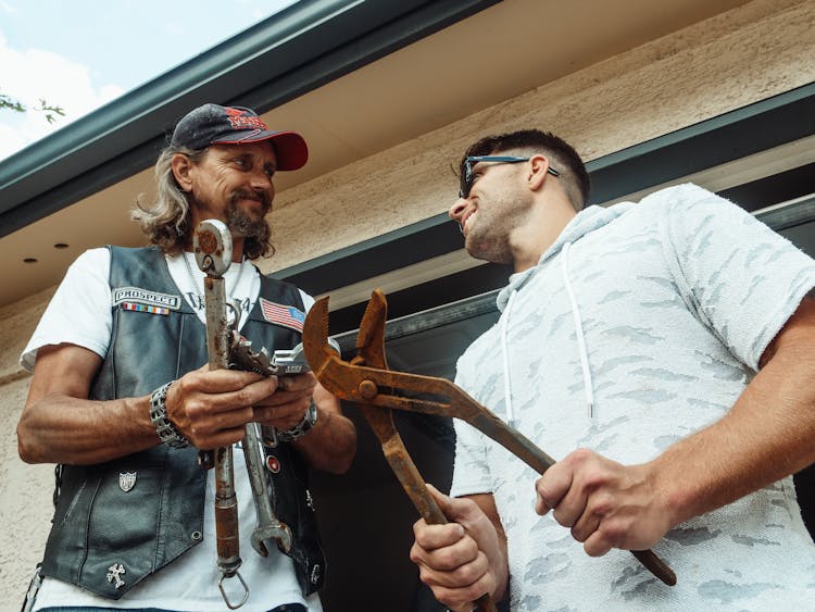 Men Holding Rusty Tools