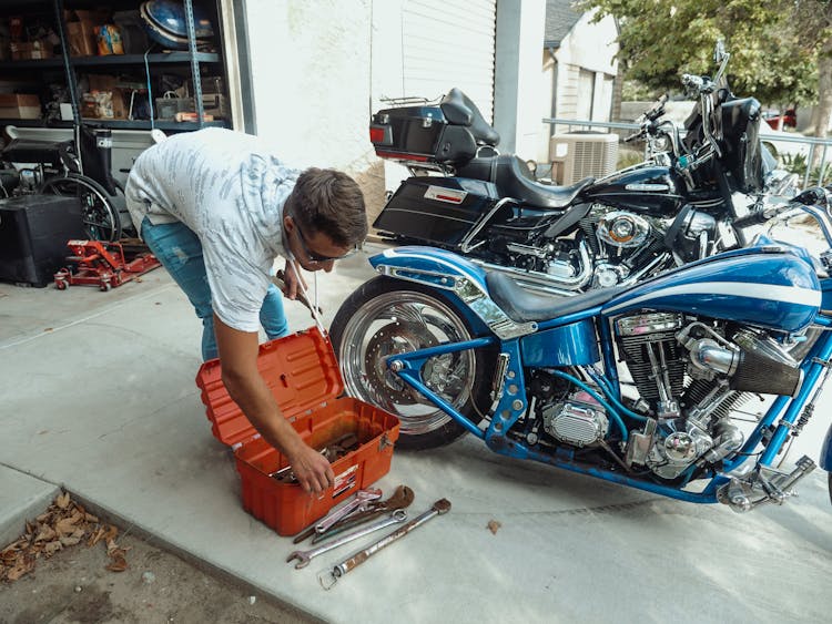 A Man Taking Out Rusty Tools From A Toolbox