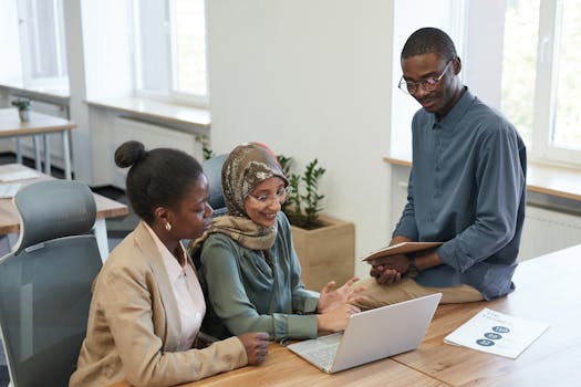 A diverse group of coworkers collaborating on a project in a modern office setting.