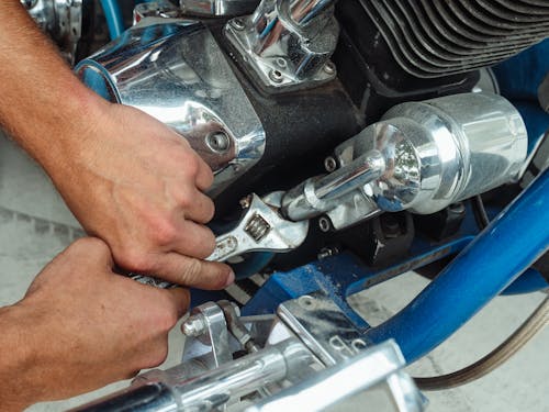 A Person Working on a Motorcycle Engine