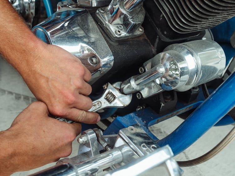 A Person Working On A Motorcycle Engine