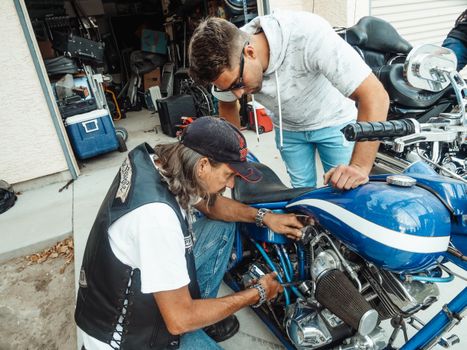Two Men Repairing a Motorcycle