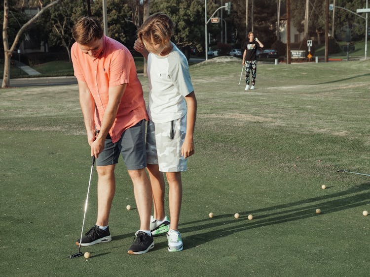 Father And Son Playing Golf Together 