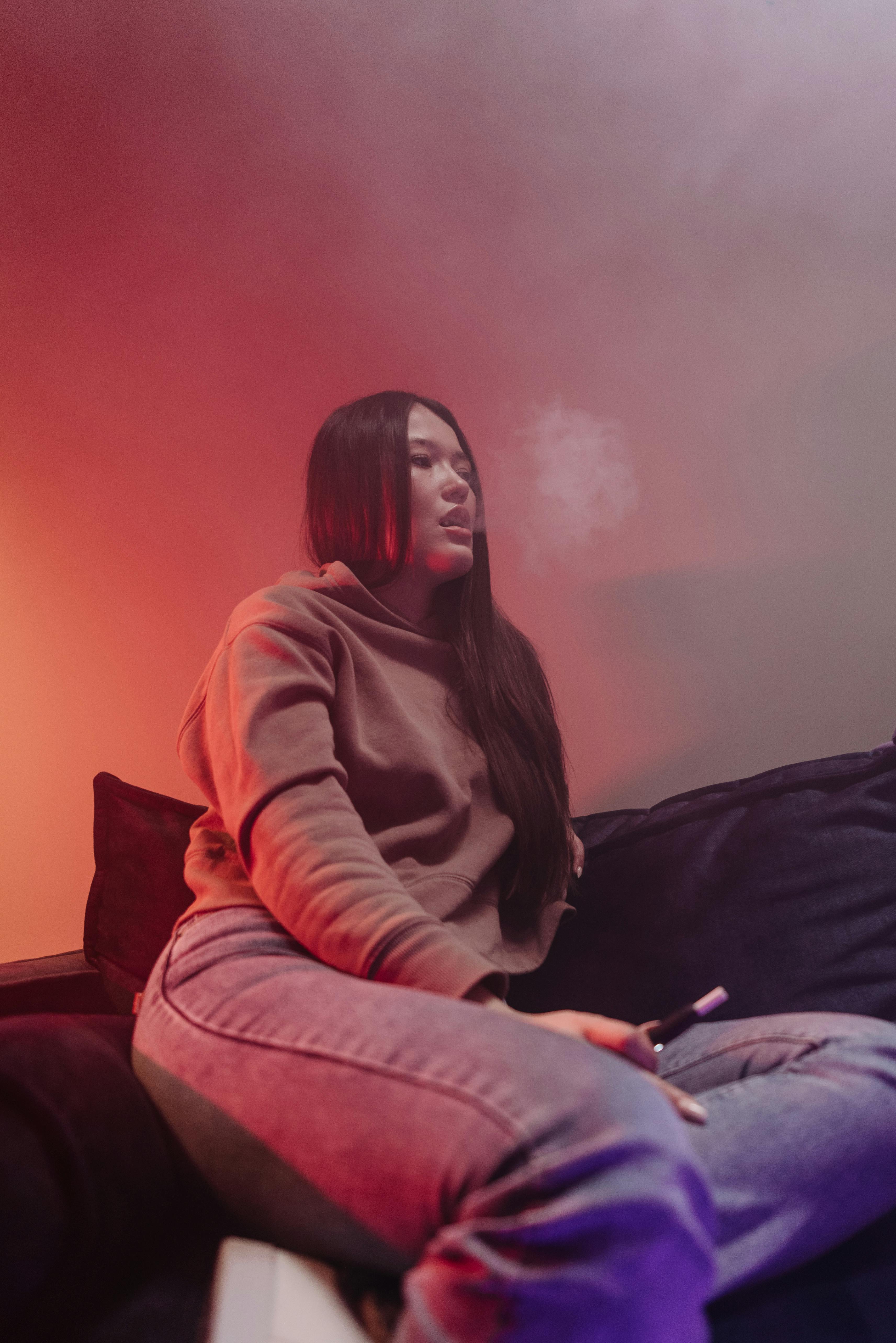 a woman smoking using vape