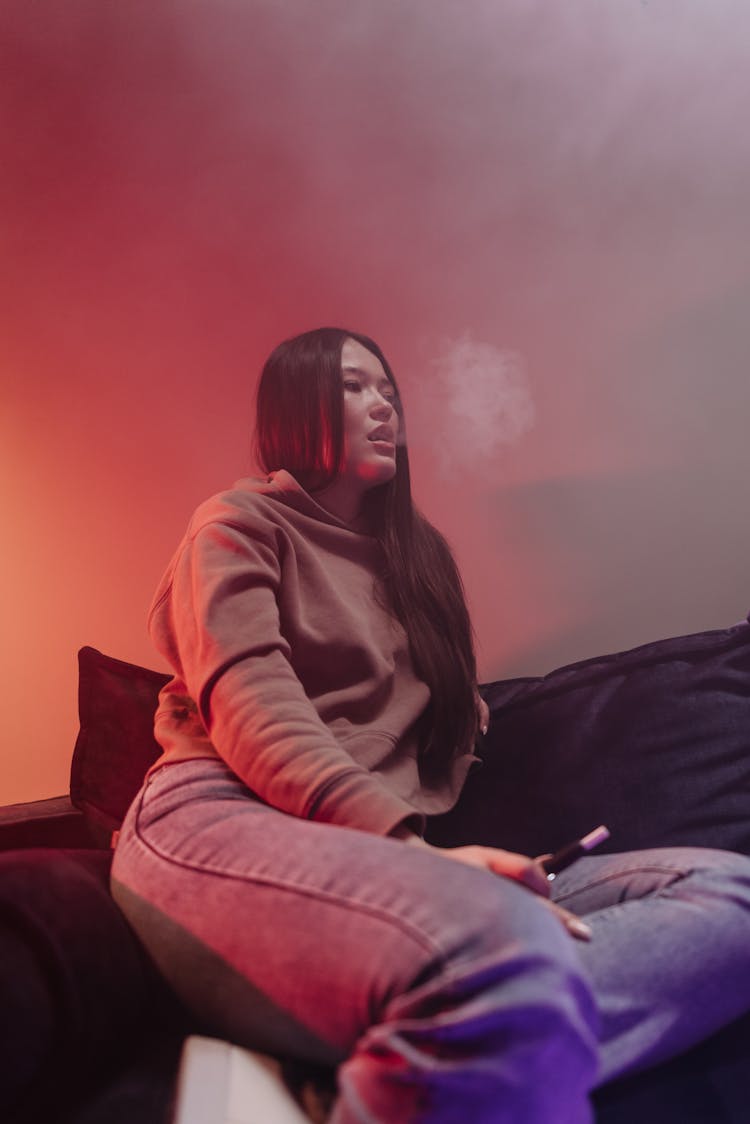 A Woman Smoking Using Vape 