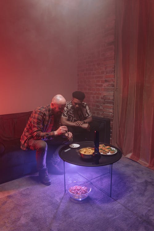 Free A Bald Man Making a Joint inside a Room Filled with Smoke Stock Photo