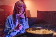 Woman in Blue Long Sleeve Shirt Sitting on Couch