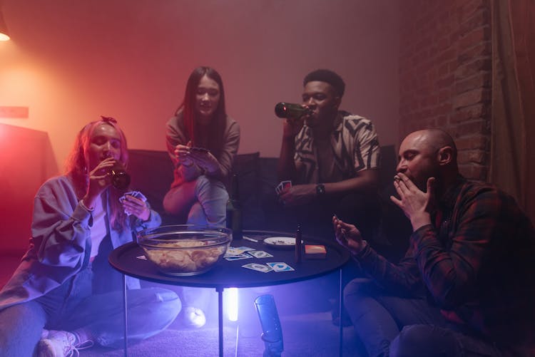 A Group Of Friends Playing Cards