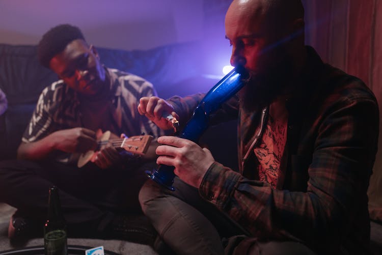 A Bearded Man Smoking With A Bong