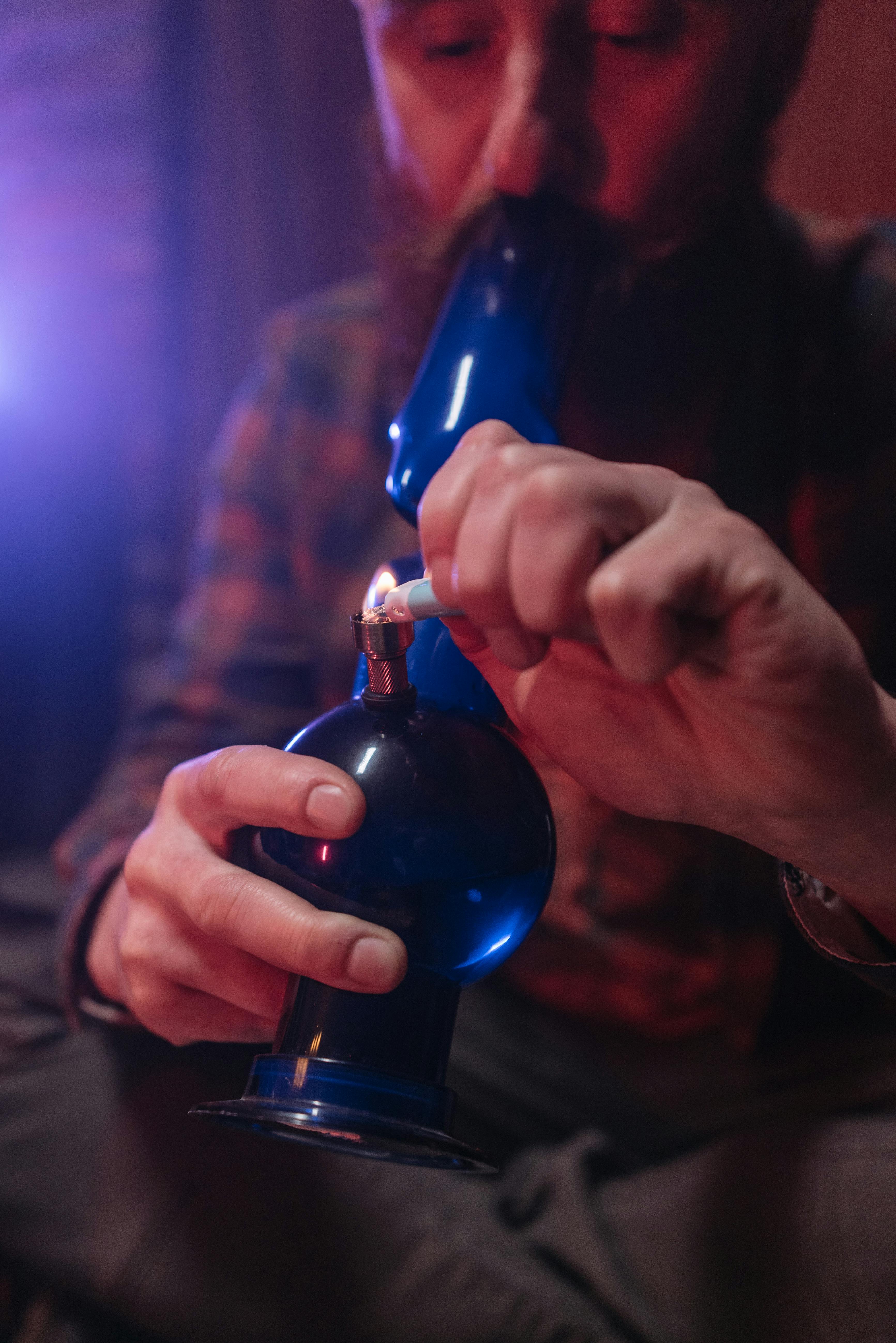 a man smoking using bong