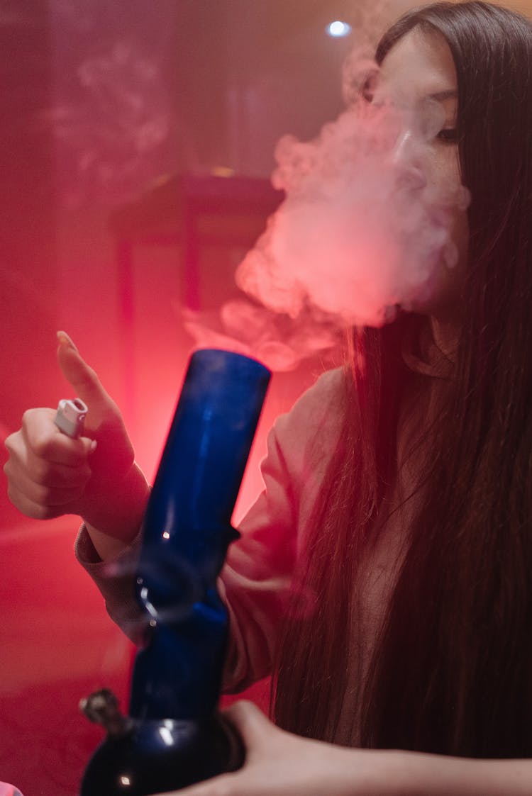 A Woman Smoking With A Bong 
