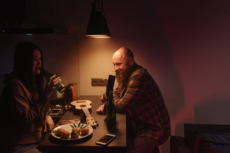 Man And Woman Sitting At The Table