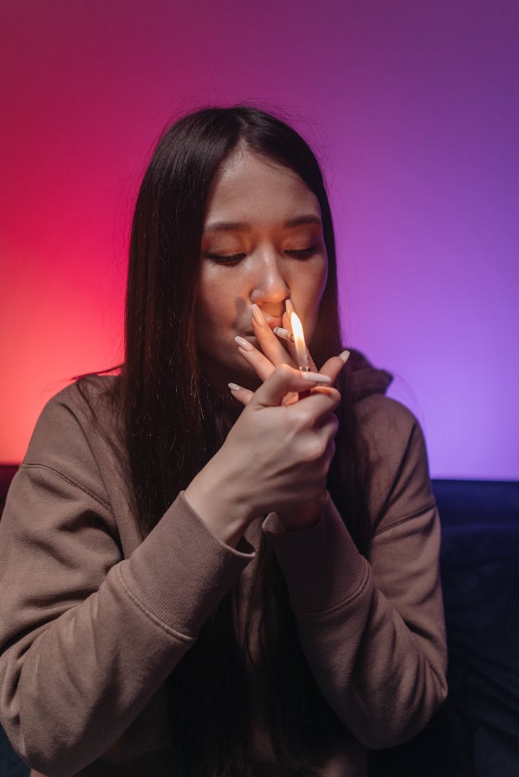 A Woman Lighting A Joint