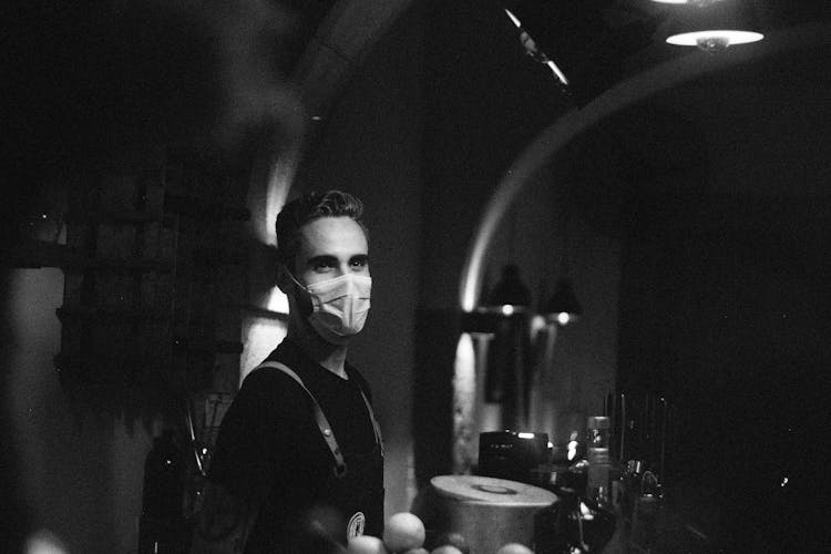 Man Wearing Facemask Standing In The Bar Counter