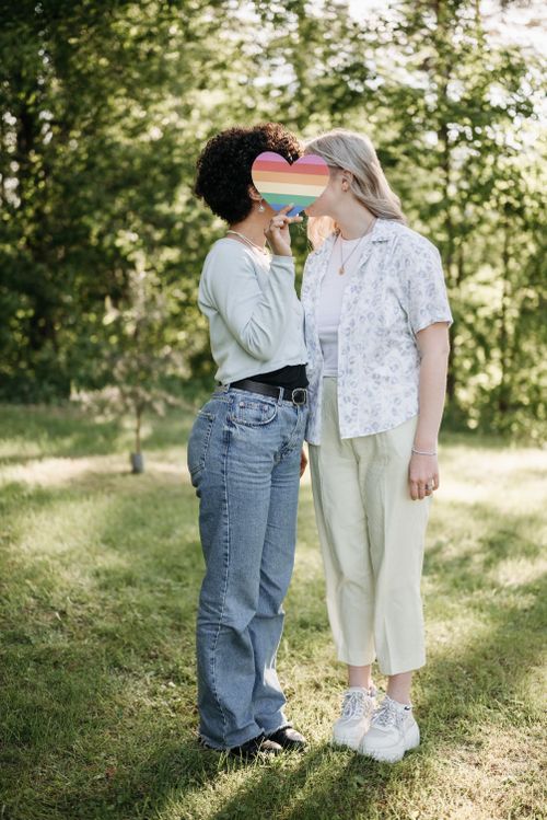 Free Two women sharing an affectionate moment in a sunny park, embodying love and inclusivity. Stock Photo