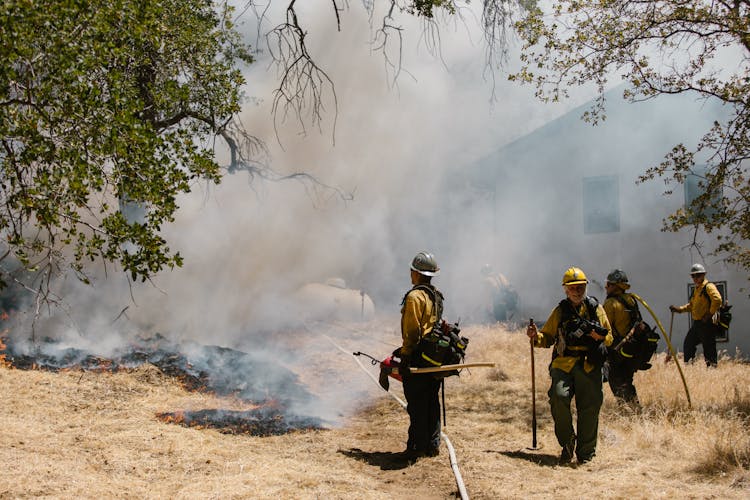 A Firefighters Stopping A Grass Fire