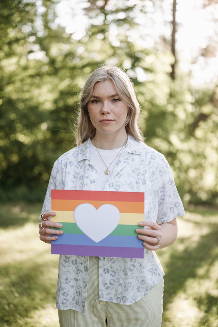 Woman Holding A Rainbow Poster With Heart Cutout
