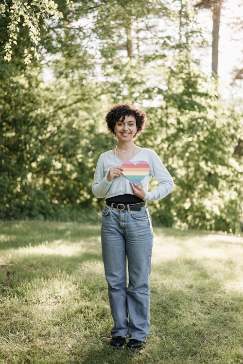 A Woman Holding LGBT Colors in Heart Shape