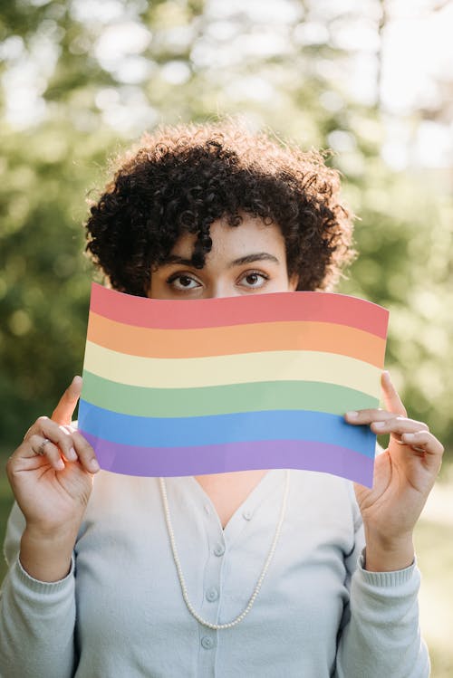 Free A Woman Holding a Rainbow Flag Stock Photo