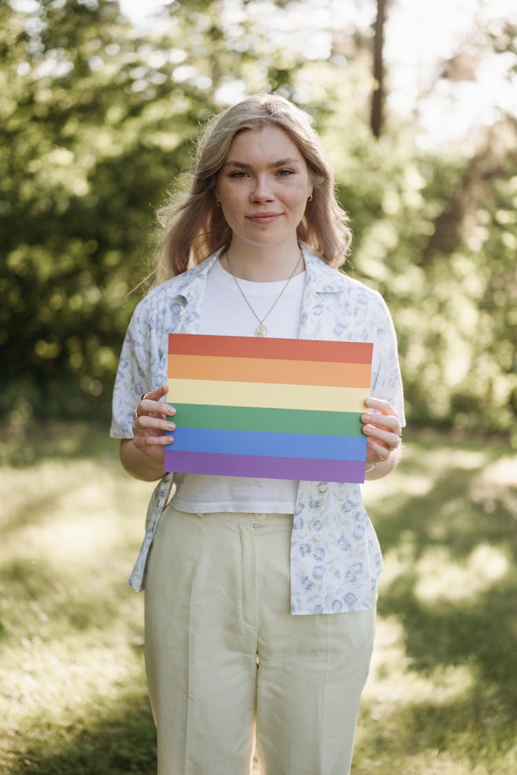 A Woman Holding A Colorful Poster