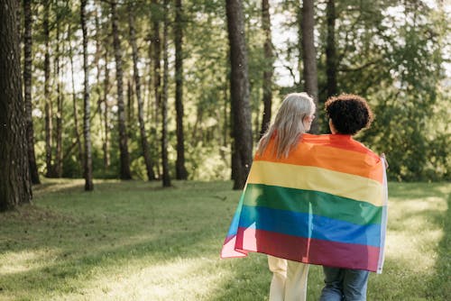 Back View of Women Draped in LGBT Flag