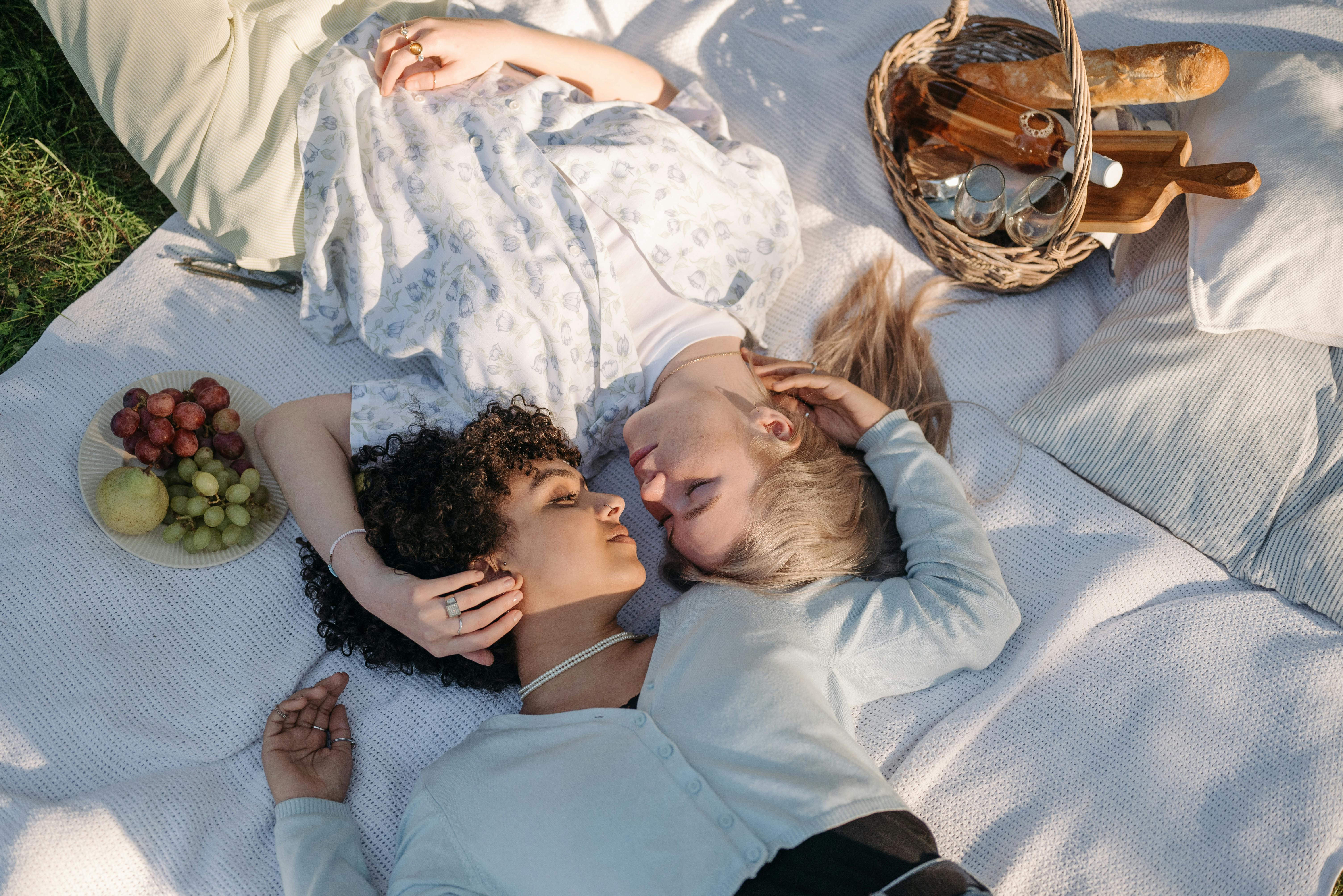 women lying on a picnic blanket