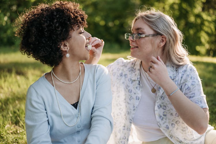 A Woman Feeding A Woman