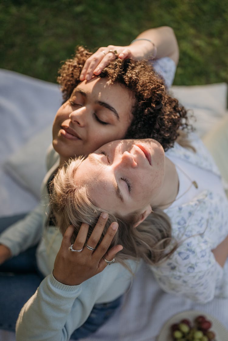 Women Holding Each Other's Head With Their Eyes Closed