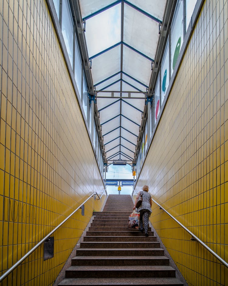 Woman Climbing Steps Of Subway Entrance