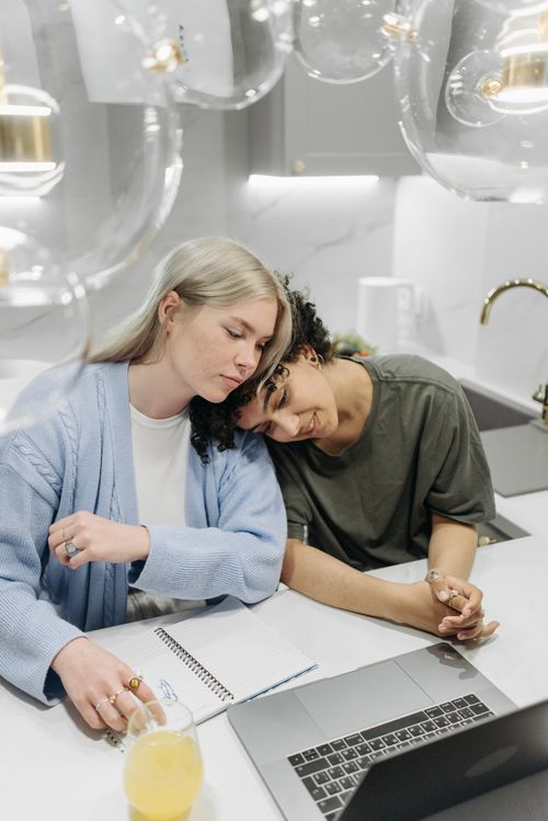 Free A loving couple relaxes at home, enjoying quality time together with a laptop. Stock Photo