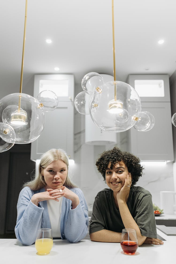 Cute Couple Sitting At Table In Kitchen