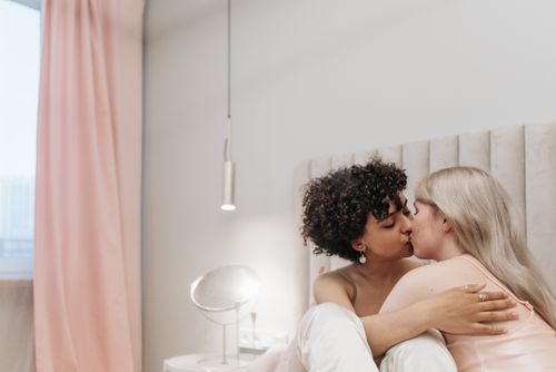 Free Intimate moment of a couple expressing love and affection in a cozy indoor setting. Stock Photo