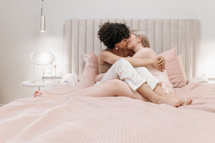 A Couple Kissing On The Bed 