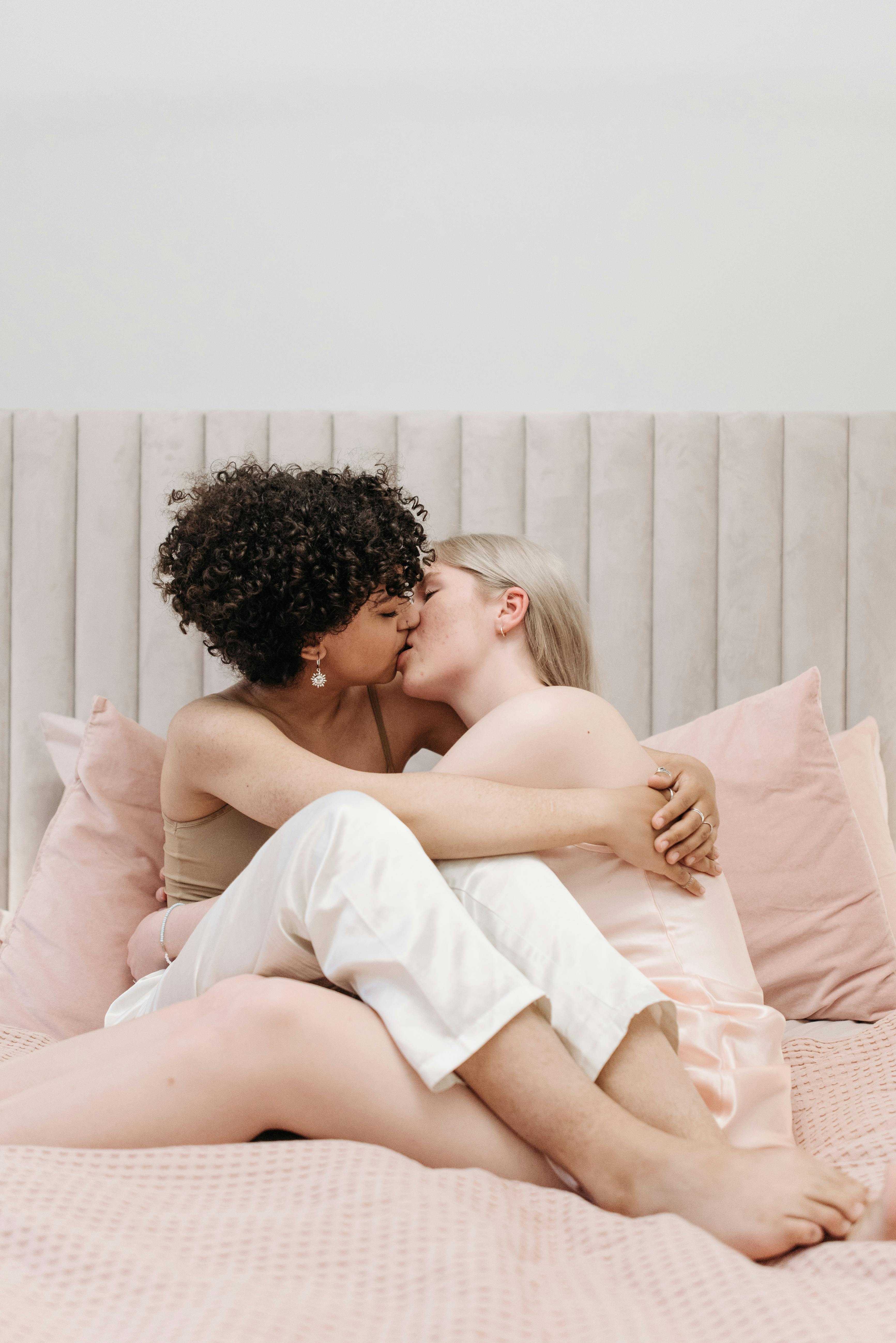 a couple kissing on the bed