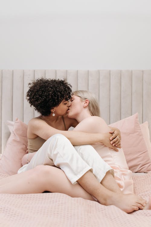 Free A Couple Kissing on the Bed  Stock Photo