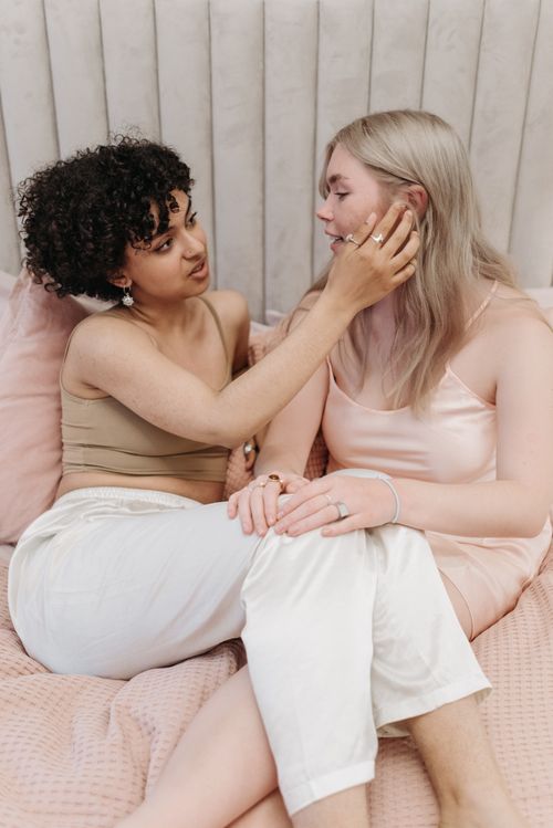 Free Two women sharing a tender and affectionate moment indoors, embodying love and connection. Stock Photo