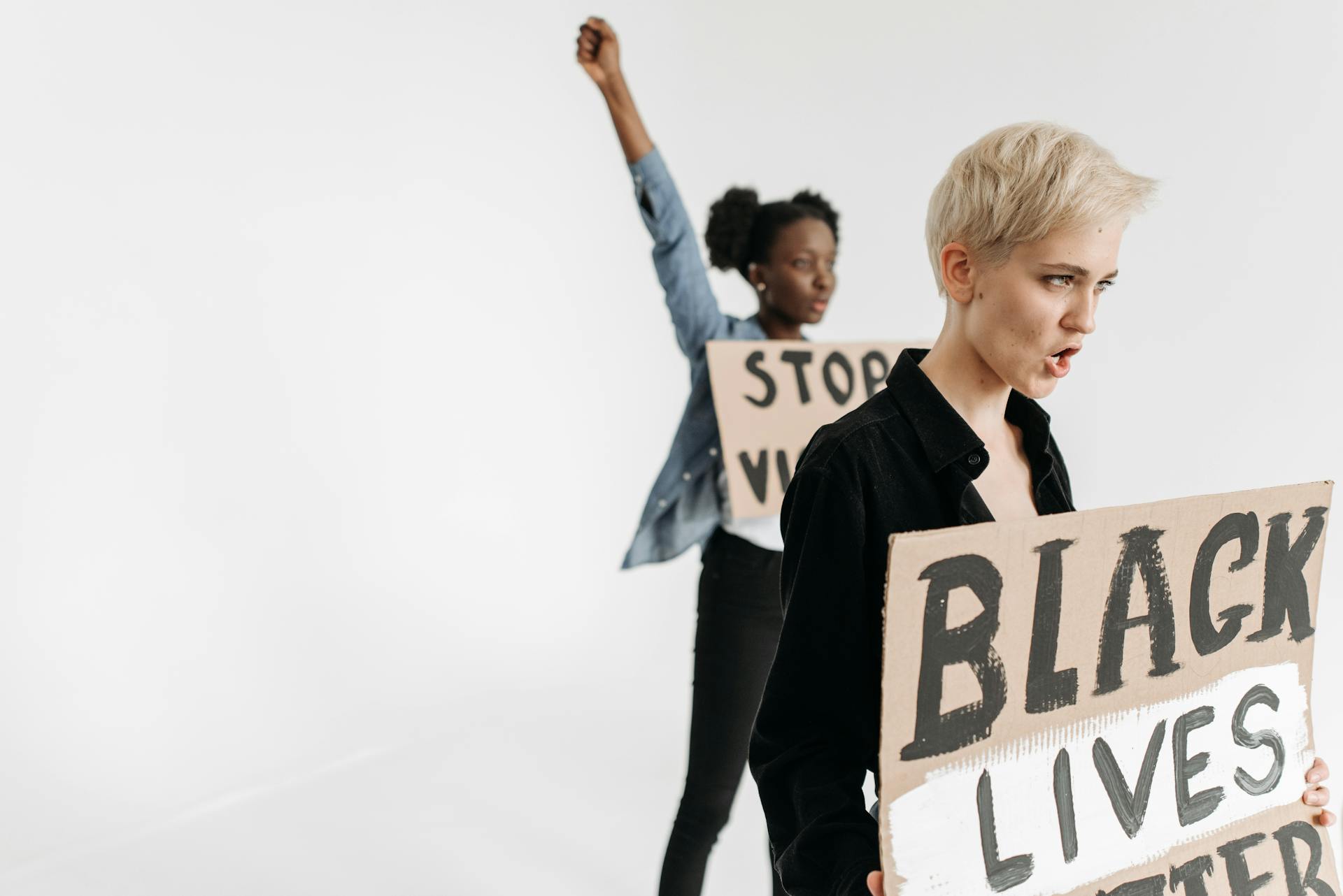 Women with Anti Racist Slogans on Banners