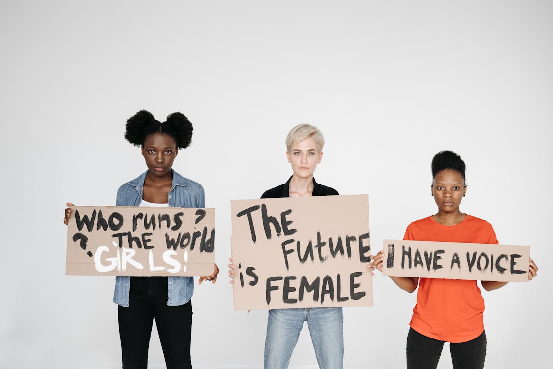 Women in Studio with Feminism Slogans on Cardboards