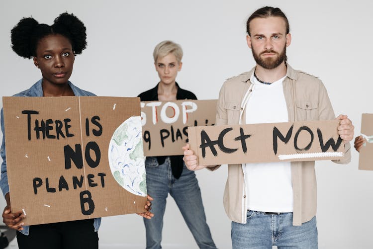 Man And Women Holding Cardboard Signs On Environment Protection