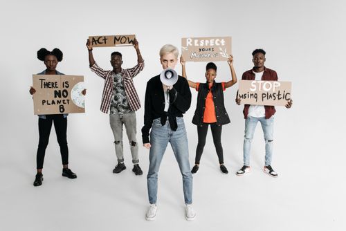 Free A diverse group of activists protesting against plastic use with signs. Stock Photo
