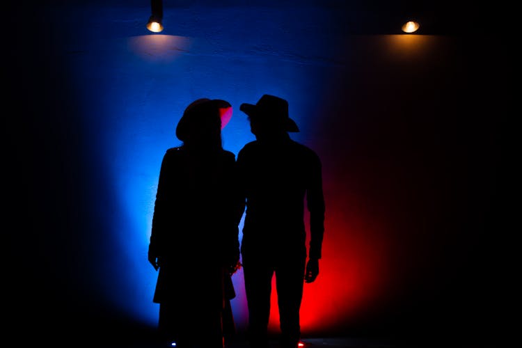 Silhouette Of A Couple Wearing Hats