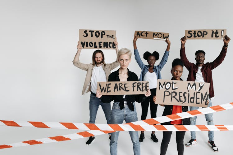 Protesters Behind A Barricade Tape