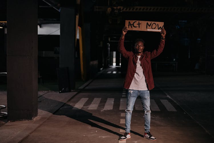 A Man Holding A Poster