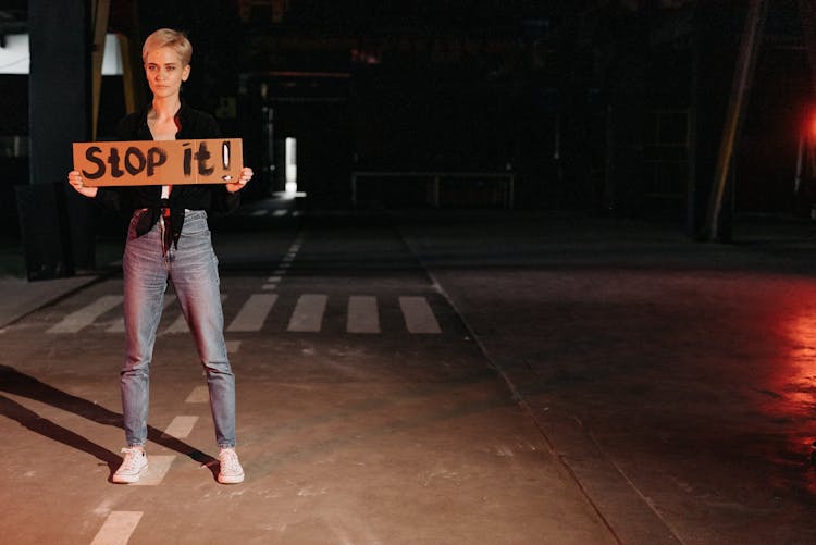 A Woman Holding Poster On The Street